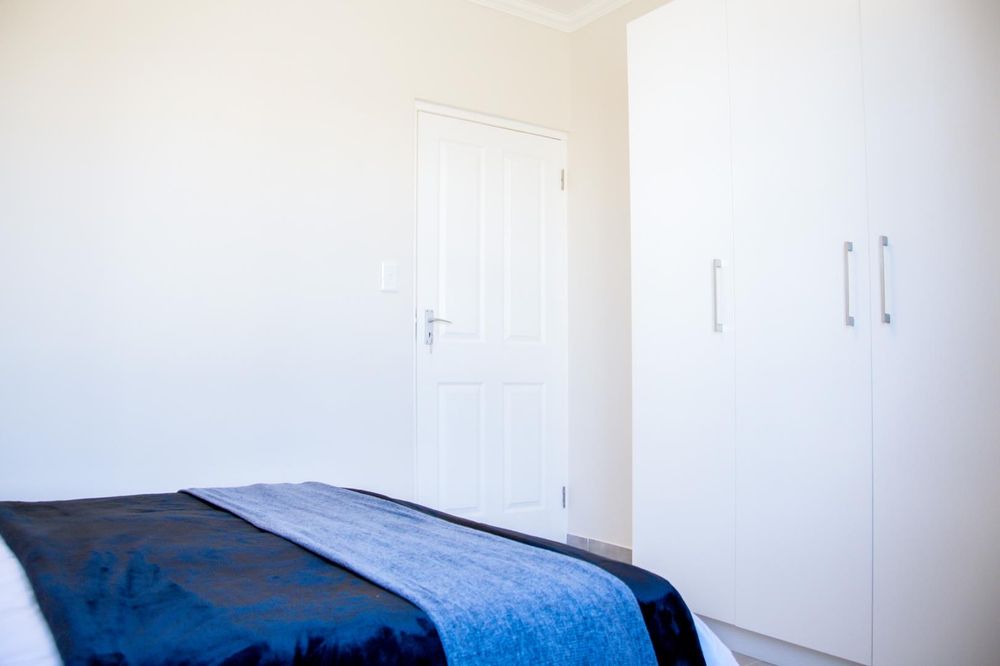 Main bedroom with built-in cupboards and ensuite bathroom.