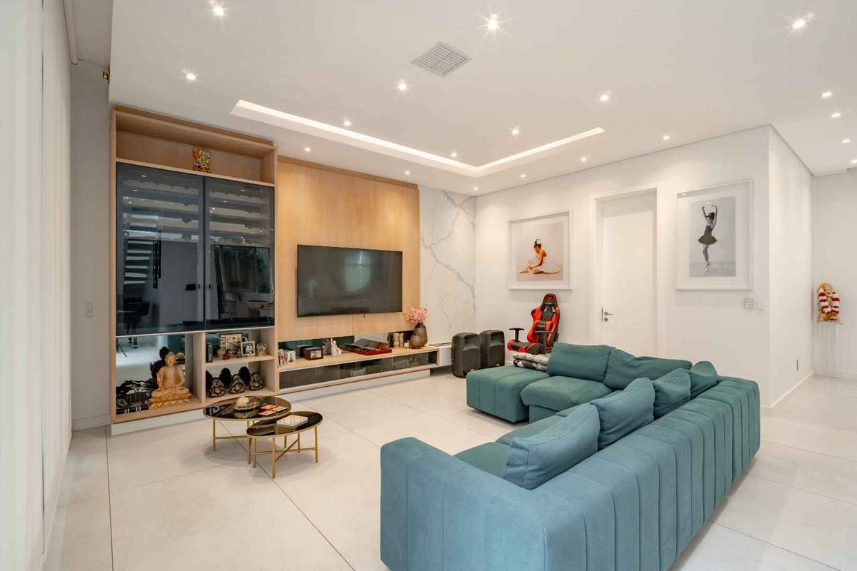 Modern living room featuring a custom built-in media unit with integrated cabinetry, recessed ceiling lighting, and large format floor tiles.