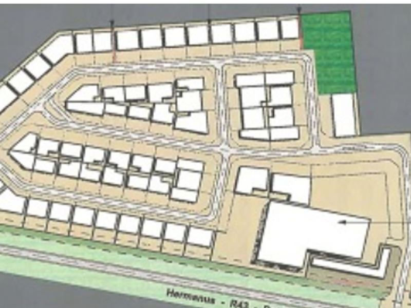 A site development plan showing the layout of commercial plots, internal road networks, and the designated anchor tenant area.