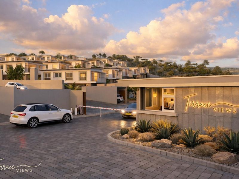 A modern security entrance and gatehouse for the Terrace Views townhouse complex, featuring paved driveway access and contemporary architectural design.