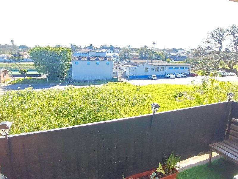 An elevated balcony area offering an open outlook over the surrounding neighbourhood and green space.