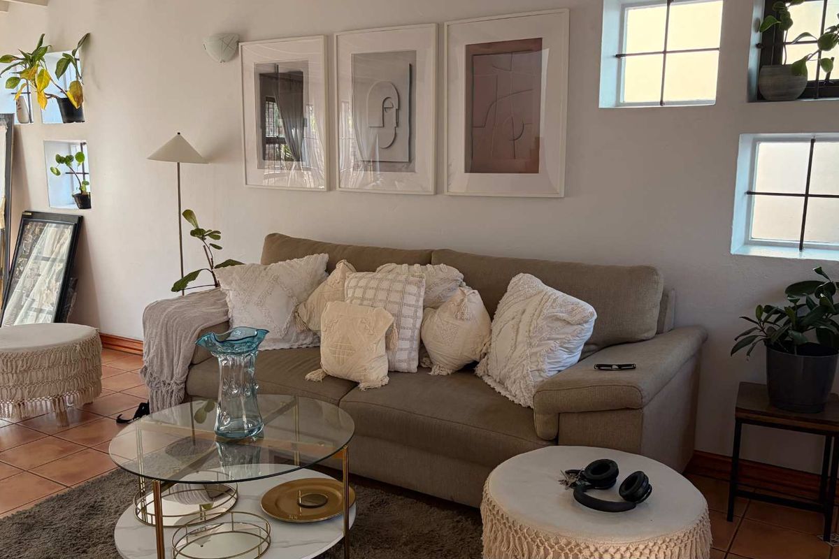 A cozy living room featuring terracotta floor tiles and grid-pane windows, creating a warm and inviting atmosphere.