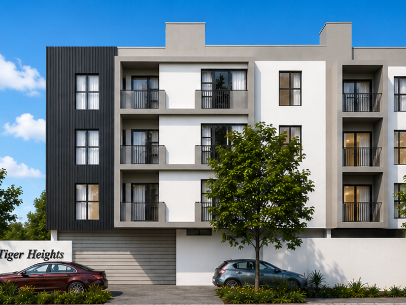 Modern multi-story apartment building facade featuring clean architectural lines, private balconies with metal railings, and a landscaped entrance area.