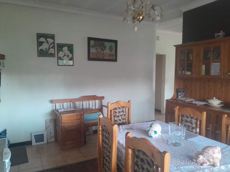 A dining room featuring tiled flooring and coved ceiling cornices, providing a functional space for family meals.