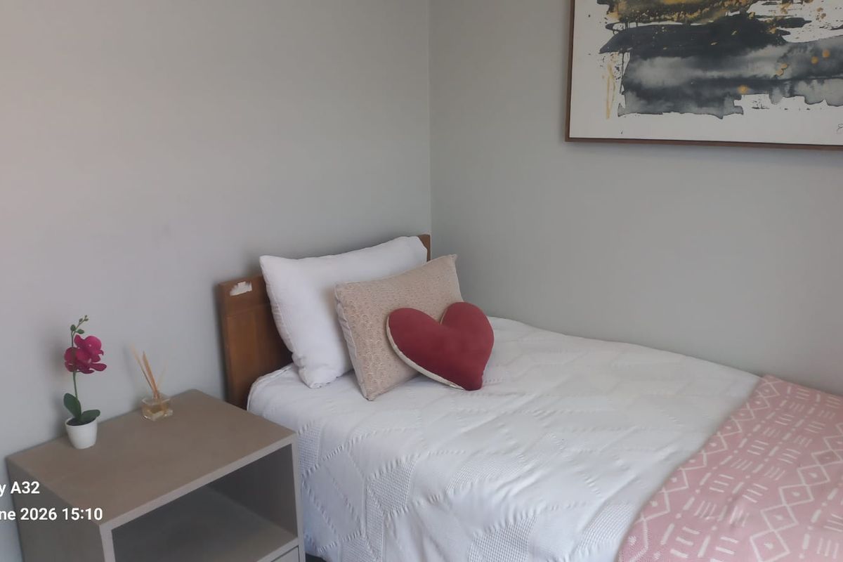 A simple bedroom featuring neutral wall finishes and a compact layout, suitable for a guest room or child's bedroom.