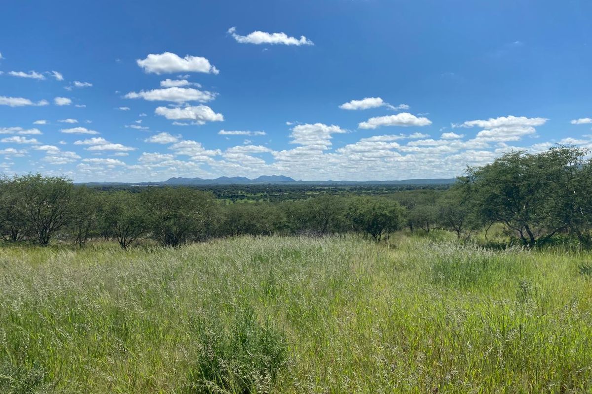 A scenic view of the expansive natural landscape and rolling hills, showcasing the property's open terrain and surrounding environment.