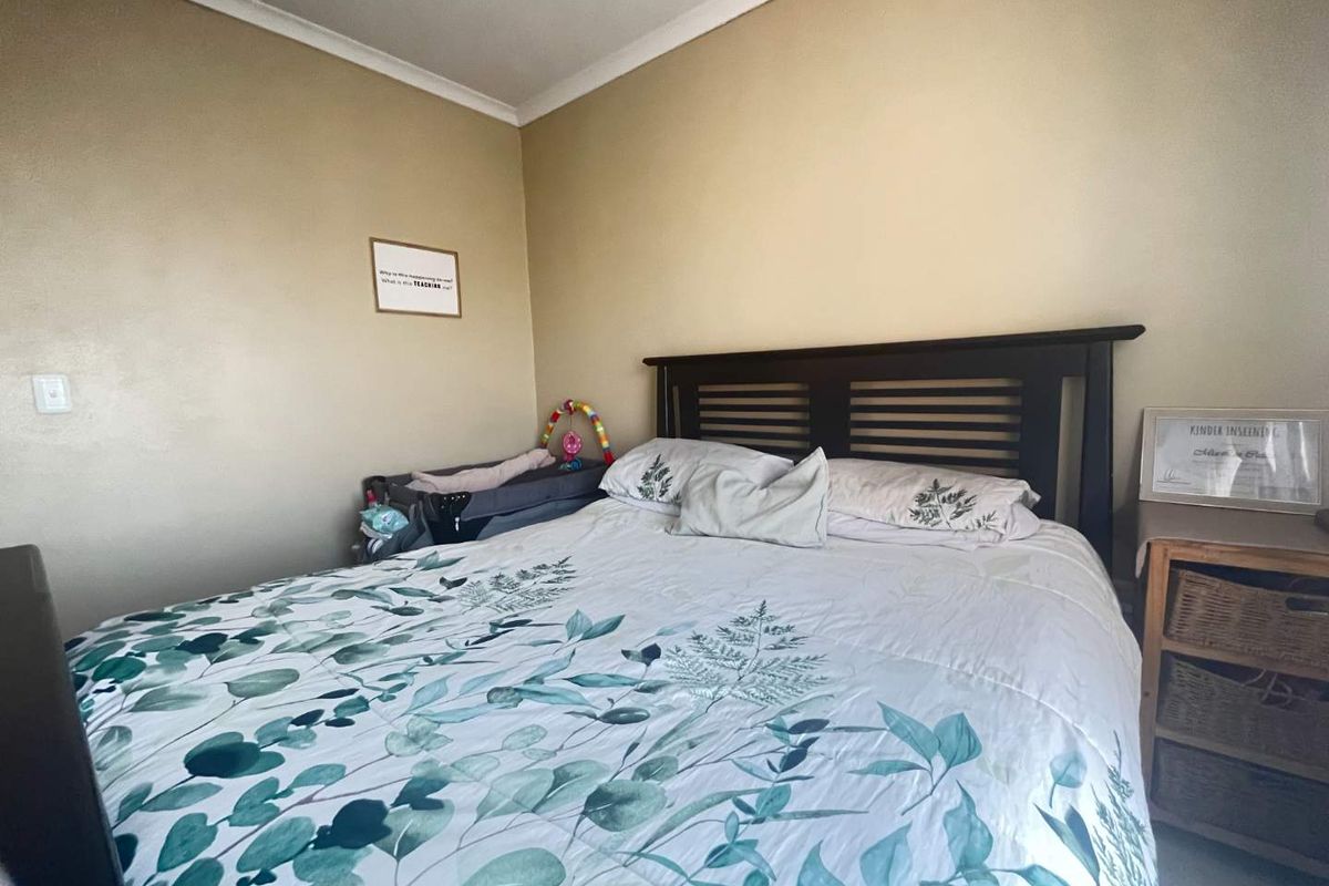 A standard bedroom featuring neutral wall finishes and decorative cove cornicing.