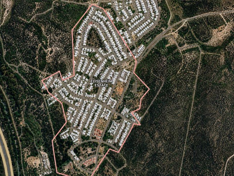 Aerial view of Elisenheim Estate showing the layout of residential plots, internal road infrastructure, and surrounding natural landscape.