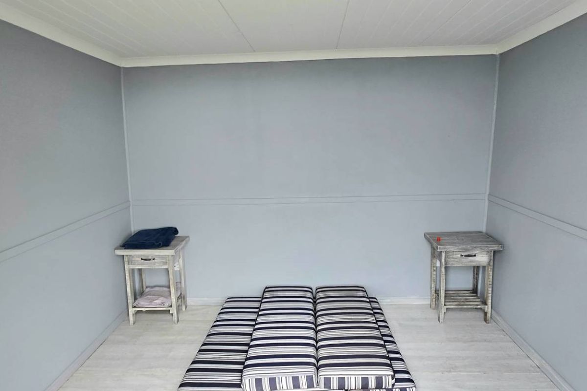 A simple, neutral-toned bedroom featuring light-colored flooring and clean wall finishes, providing a versatile space ready for personalization.