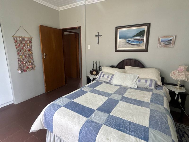 A functional bedroom featuring tiled flooring and a built-in wardrobe, offering a neutral base for potential interior updates.