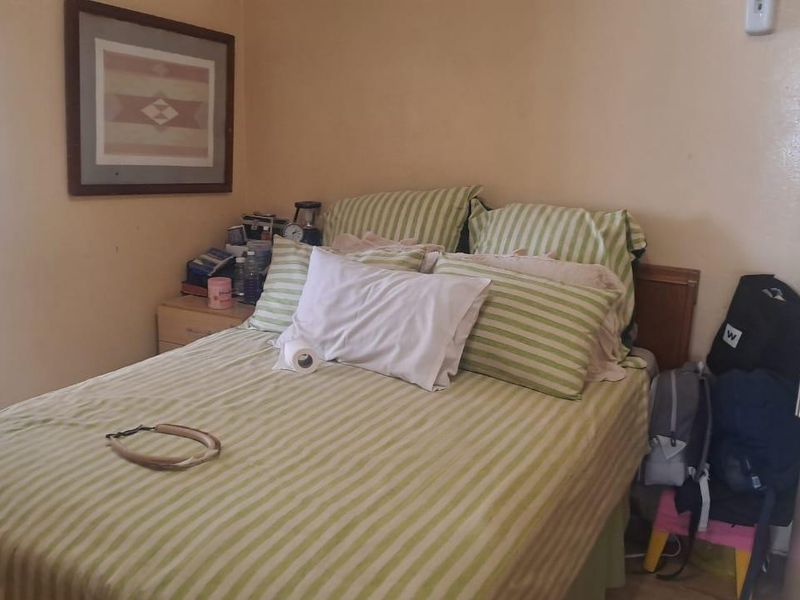A compact bedroom featuring standard finishes, suitable for a single bed or guest room setup.
