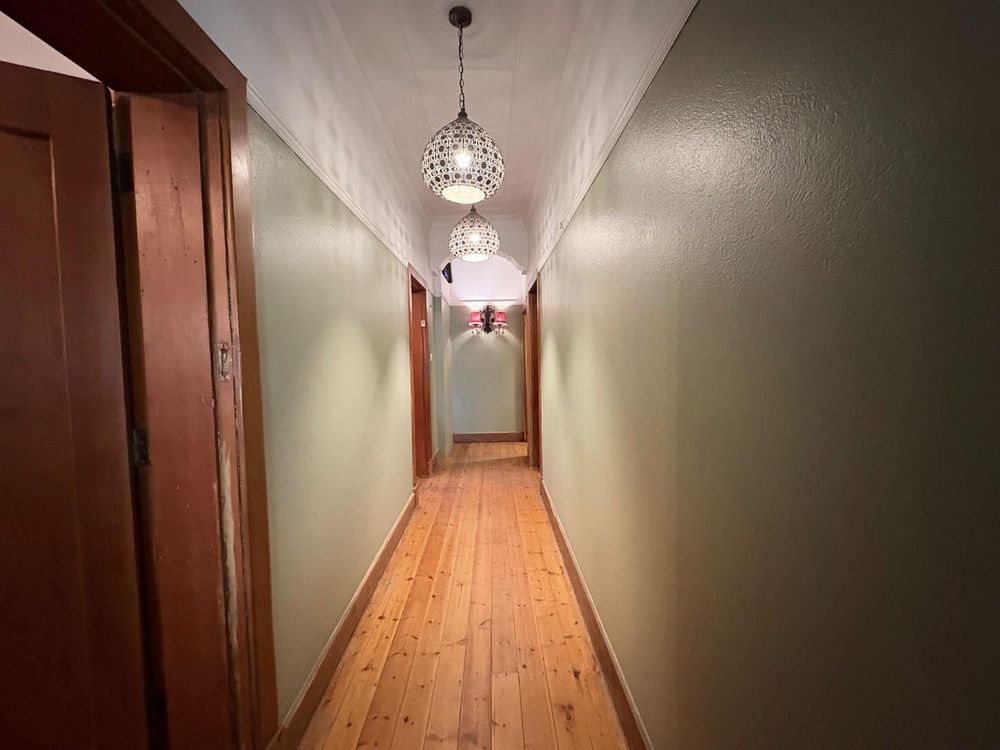 Hallway leading to rooms and kitchen area.