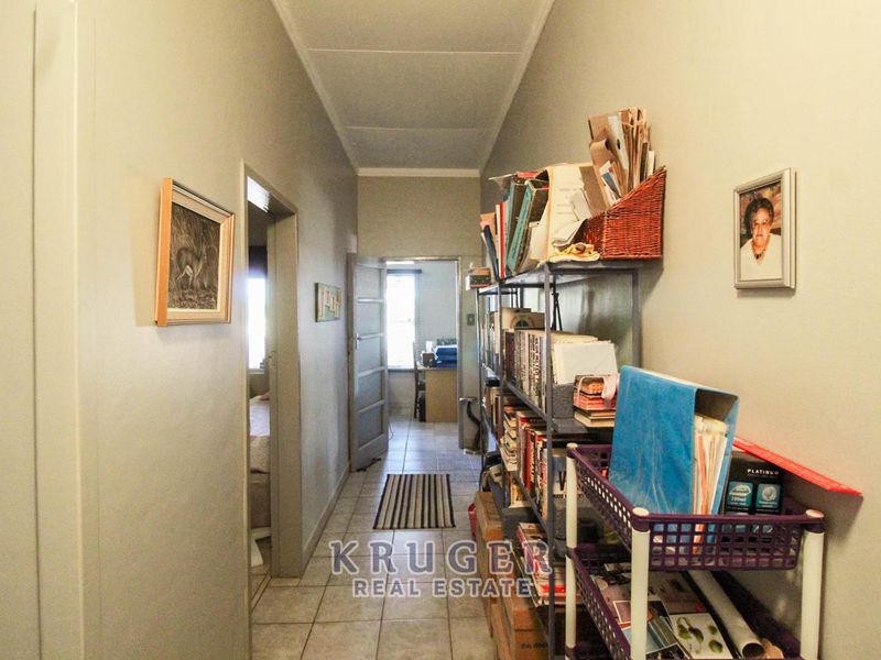 A functional hallway with tiled flooring providing access to adjacent rooms within the home.