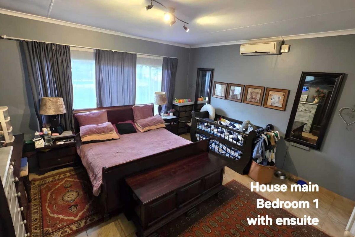 Spacious main bedroom featuring tiled flooring, split-system air conditioning, and neutral wall finishes.