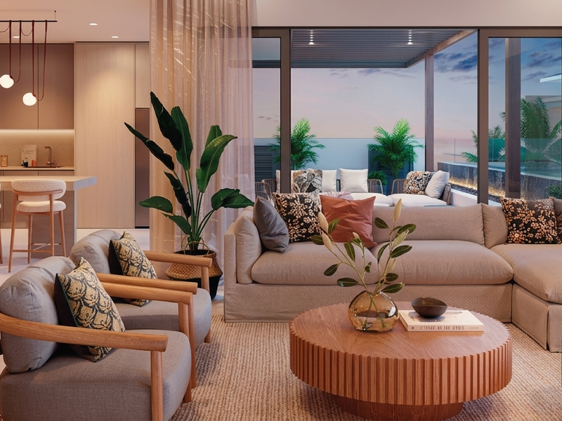 Spacious open-plan living area featuring a modern kitchen with island, seamless flow to an outdoor patio, and high-quality finishes throughout.