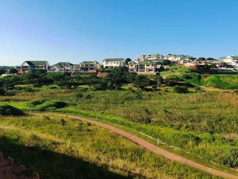 A scenic elevated view overlooking a green landscape and residential estate.