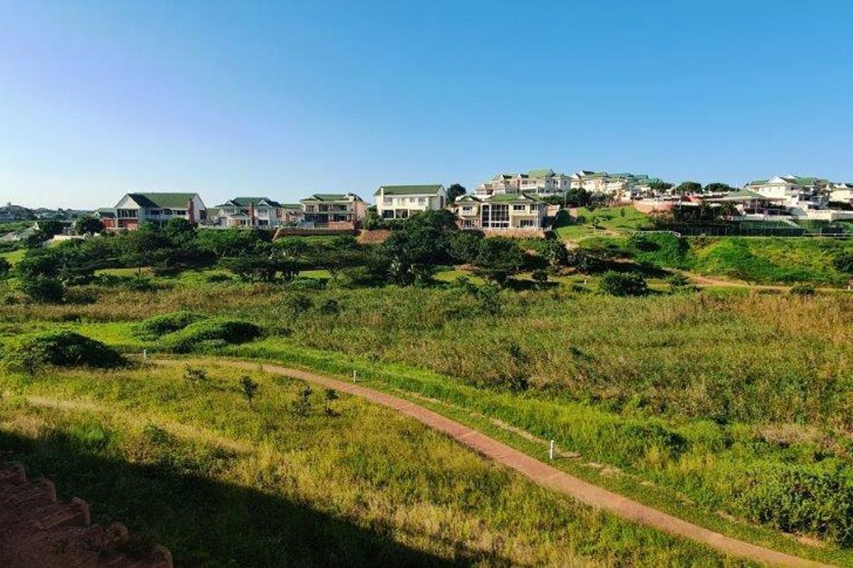 A scenic elevated view overlooking a green landscape and residential estate.