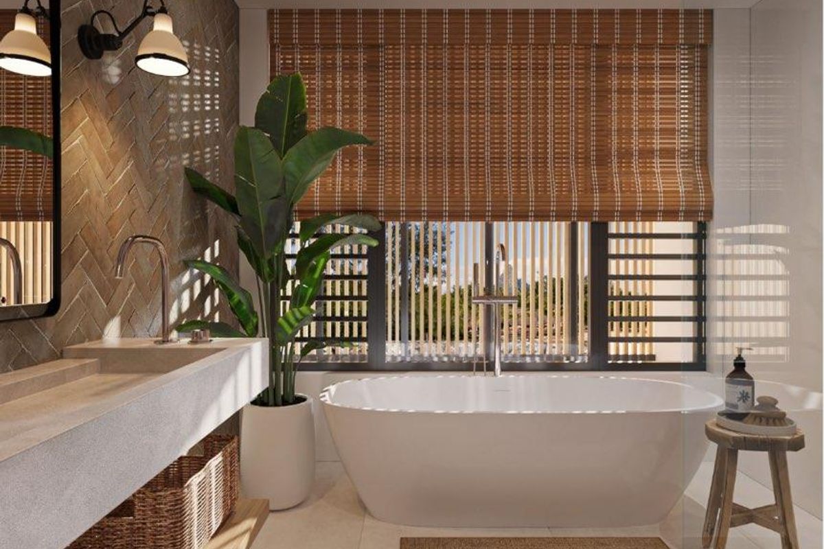 A modern, high-end bathroom featuring a freestanding bathtub, a custom stone vanity, herringbone-patterned wall tiles, and integrated recessed lighting.