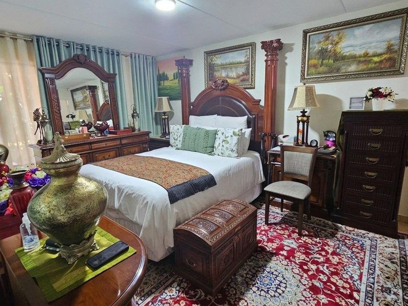 A well-maintained bedroom featuring a built-in wardrobe and neutral wall finishes, providing a comfortable and functional sleeping space.