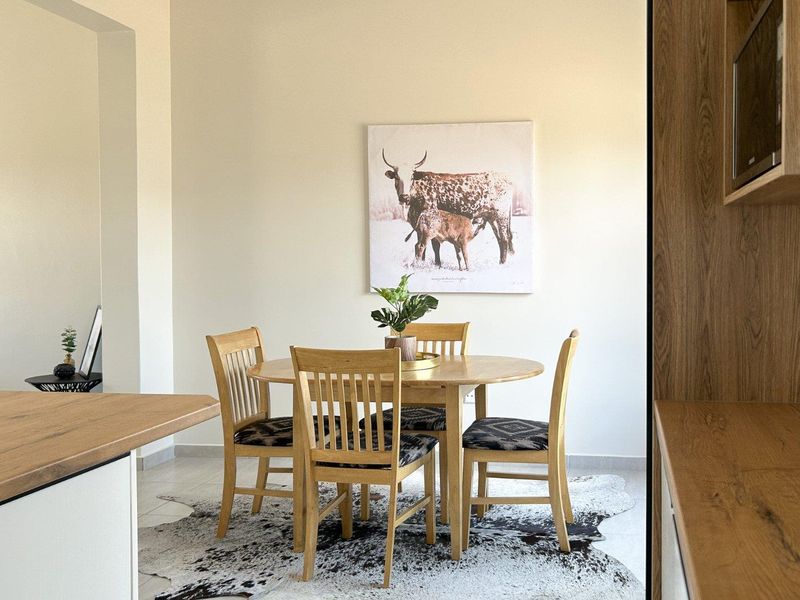 A bright and modern dining area featuring tiled flooring and integrated cabinetry, creating a clean and functional space for meals.