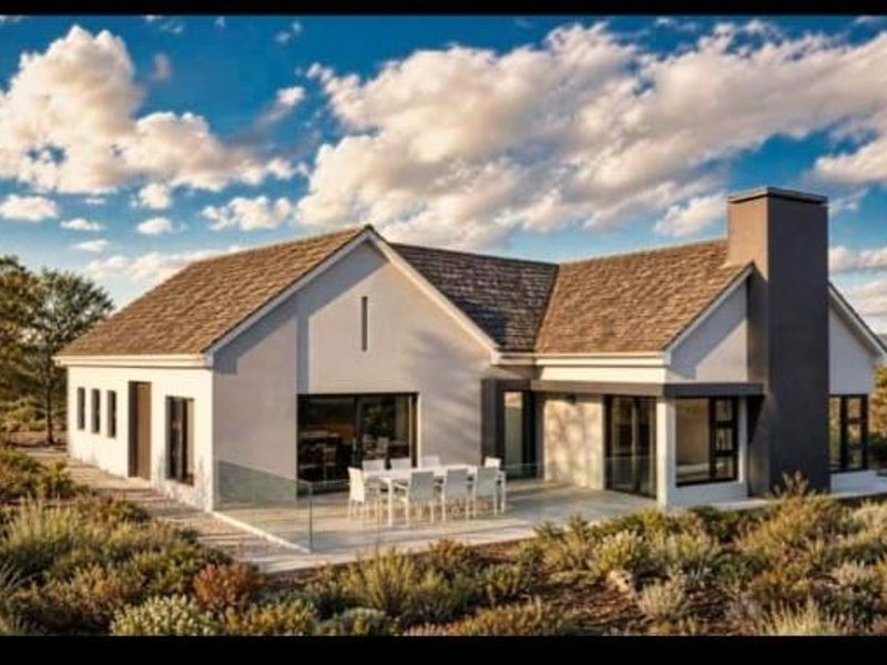 A modern rear elevation featuring a spacious paved patio, glass balustrades, and a prominent chimney, set against a landscaped garden.