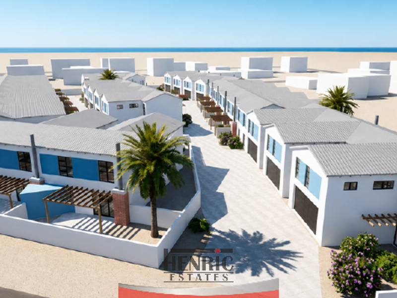 An aerial view of a modern townhouse development featuring pitched roofs, paved driveways, and private outdoor pergolas within a coastal estate setting.