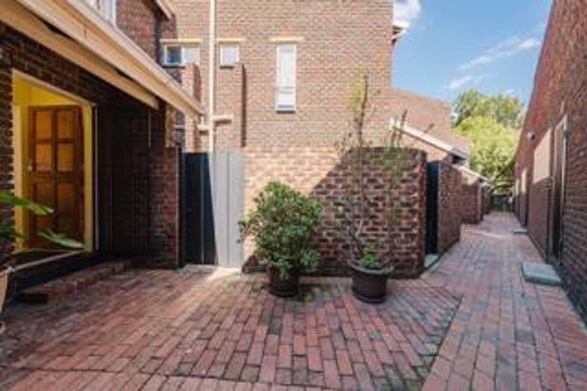 A private rear courtyard featuring classic face brick construction and durable brick paving, providing a low-maintenance outdoor space.