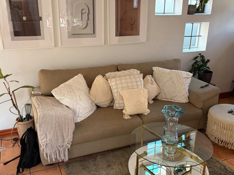 A cozy living room area featuring warm terracotta floor tiles and unique recessed wall niches, creating a comfortable and inviting atmosphere.