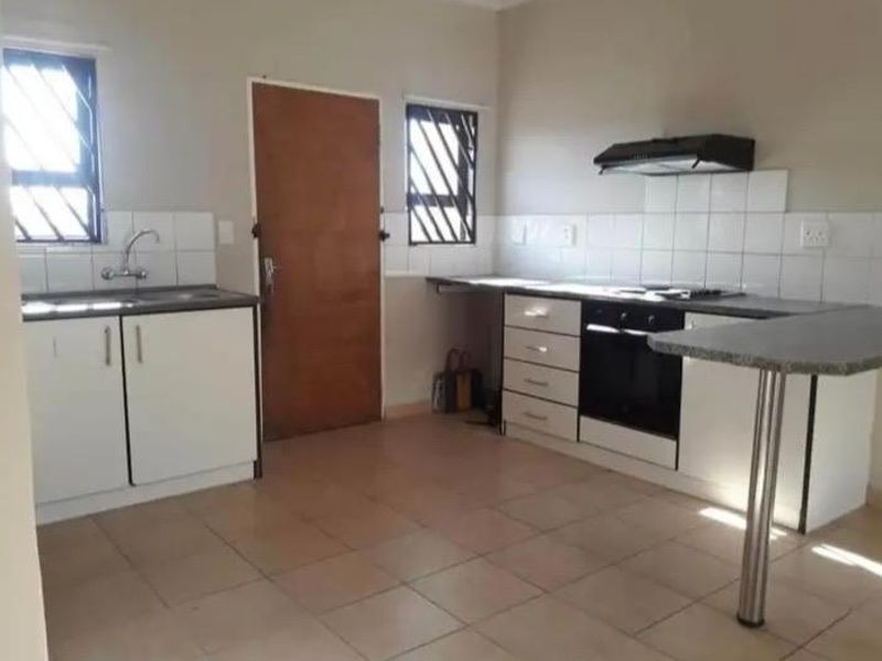 A functional kitchen featuring built-in cabinetry, a built-in oven with extractor fan, tiled backsplash, and tiled flooring.