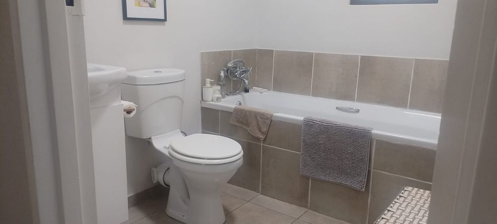 Second bathroom with bath, toilet and basin in a vanity cupboard