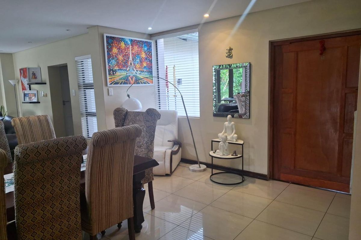A view of the interior living space featuring tiled flooring, recessed lighting, and a solid timber entrance door.