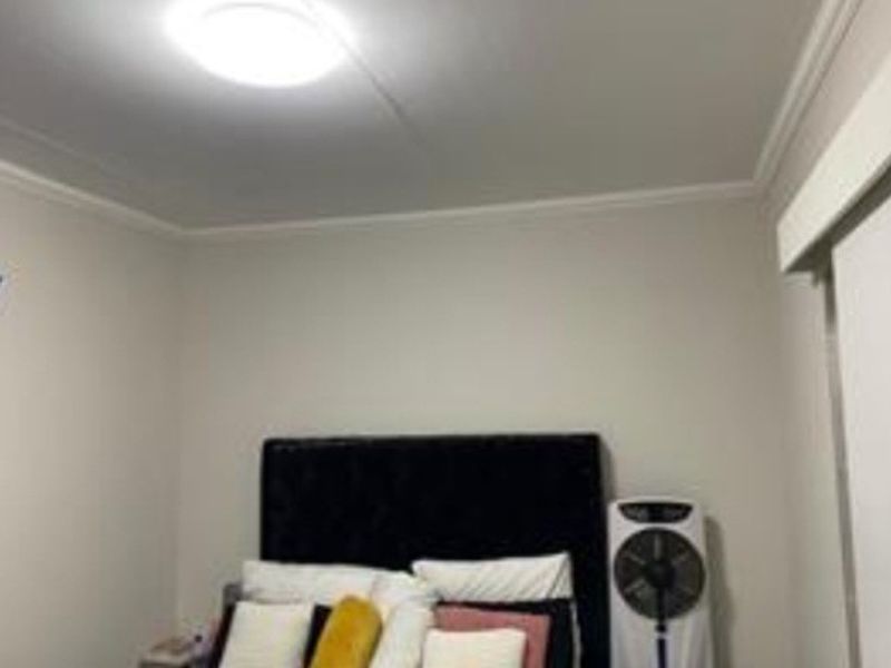 A standard bedroom featuring neutral wall finishes and a central ceiling light fixture.