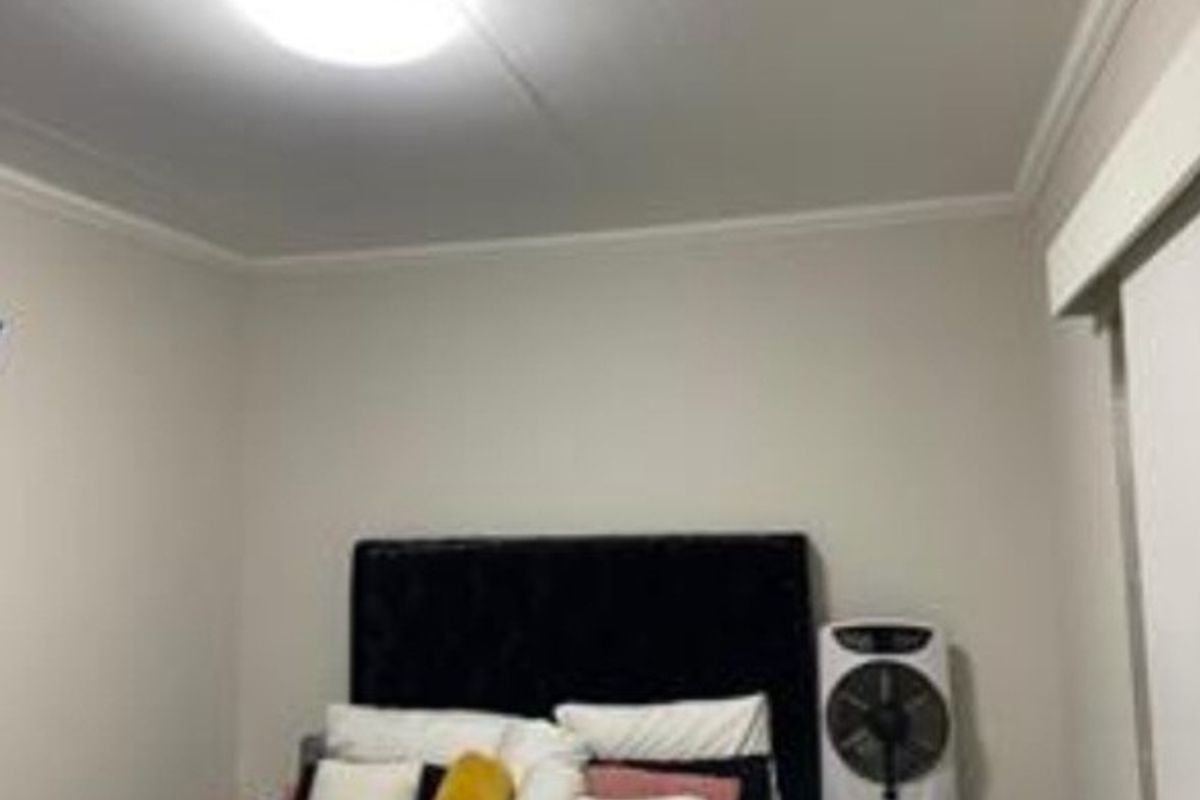 A standard bedroom featuring neutral wall finishes and a central ceiling light fixture.