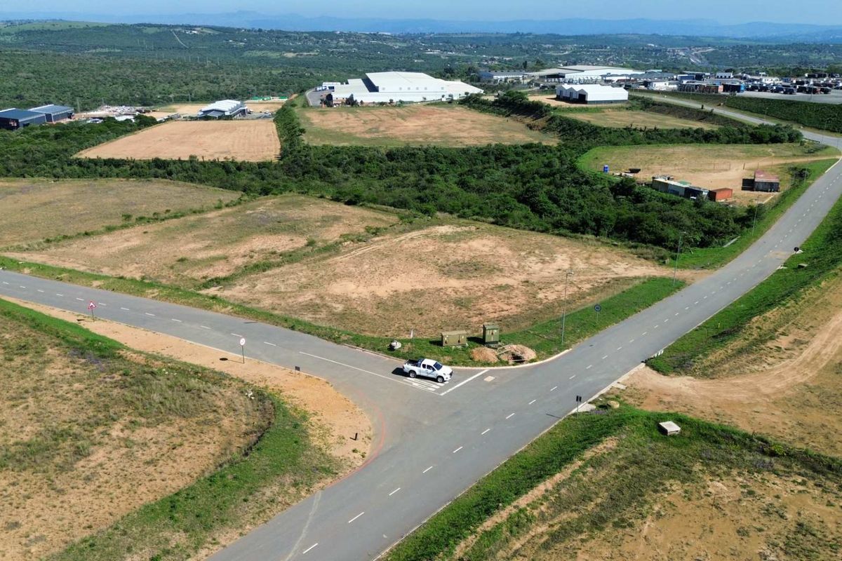 Aerial view of a developed industrial land parcel featuring established asphalt road infrastructure and utility access points within a larger industrial estate.