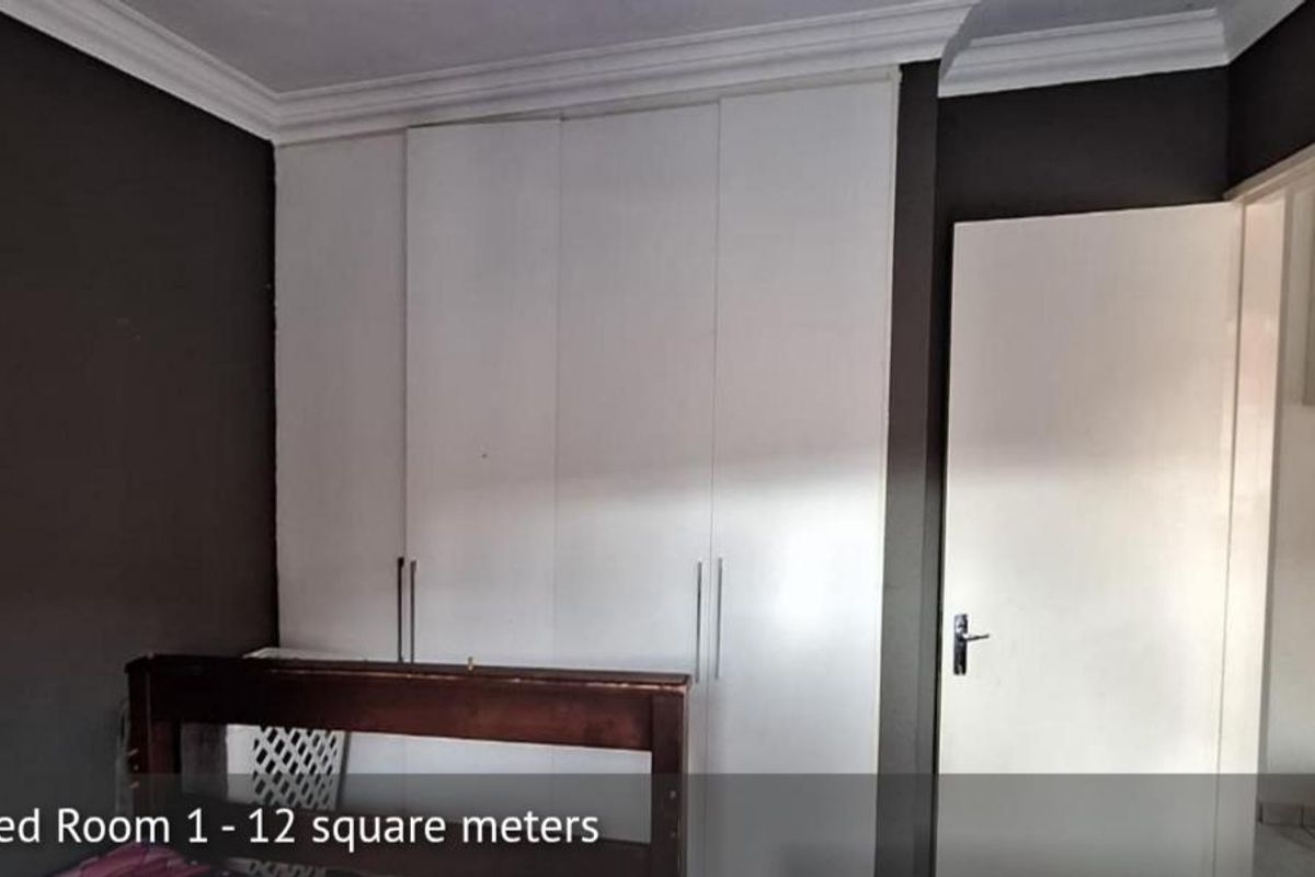 A bedroom featuring built-in cupboards and crown molding, offering 12 square meters of space.