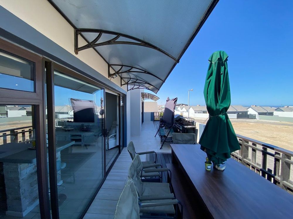 First-floor balcony with distant sea view