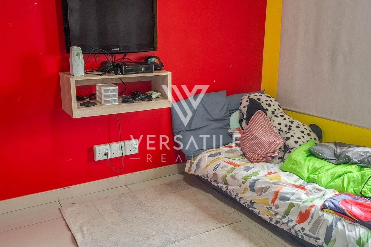 A bedroom featuring bold red and yellow wall finishes, tiled flooring, and a wall-mounted shelving unit for media equipment.