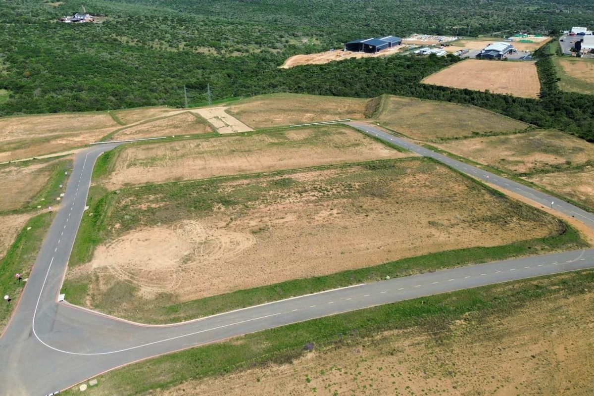 Aerial view of a cleared industrial land parcel featuring established paved access roads and surrounding infrastructure in a developing industrial estate.