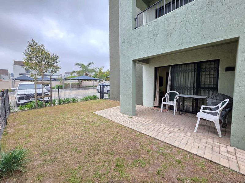 Ground floor apartment featuring a paved patio area, small private garden, and secure sliding door access.