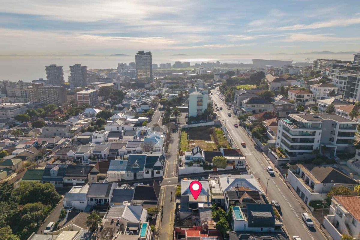 An aerial view of the property location within a dense urban residential neighborhood, showcasing proximity to city infrastructure and coastal surroundings.