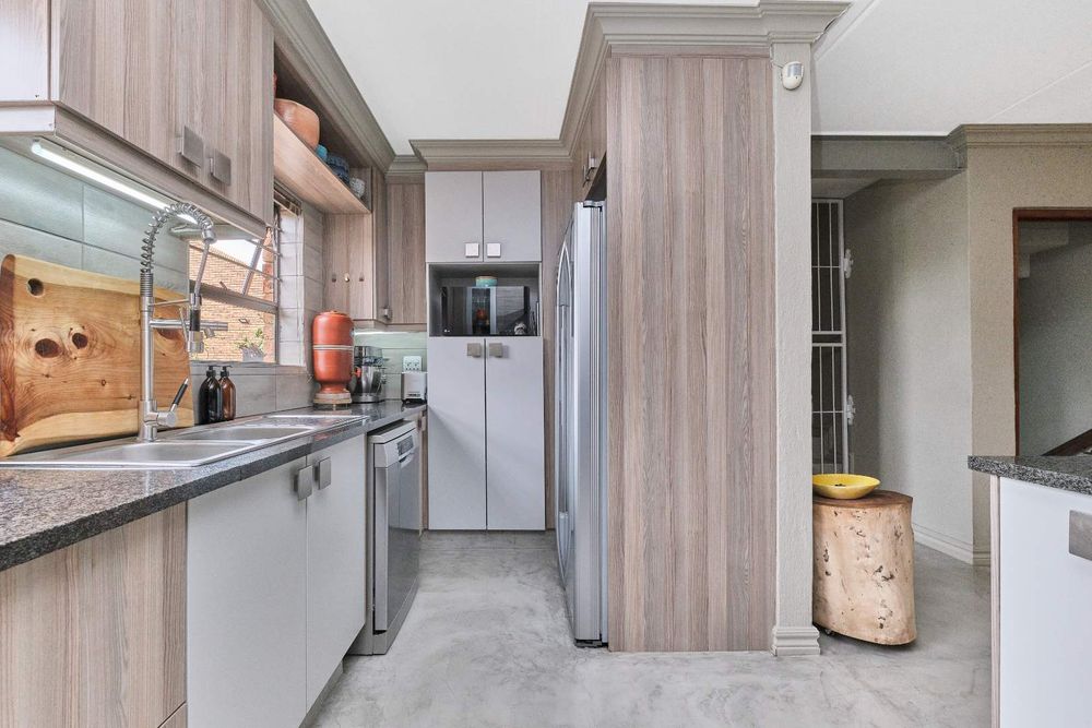 Built-in Hitachi fidge, space for dishwasher, with laundry in garage.