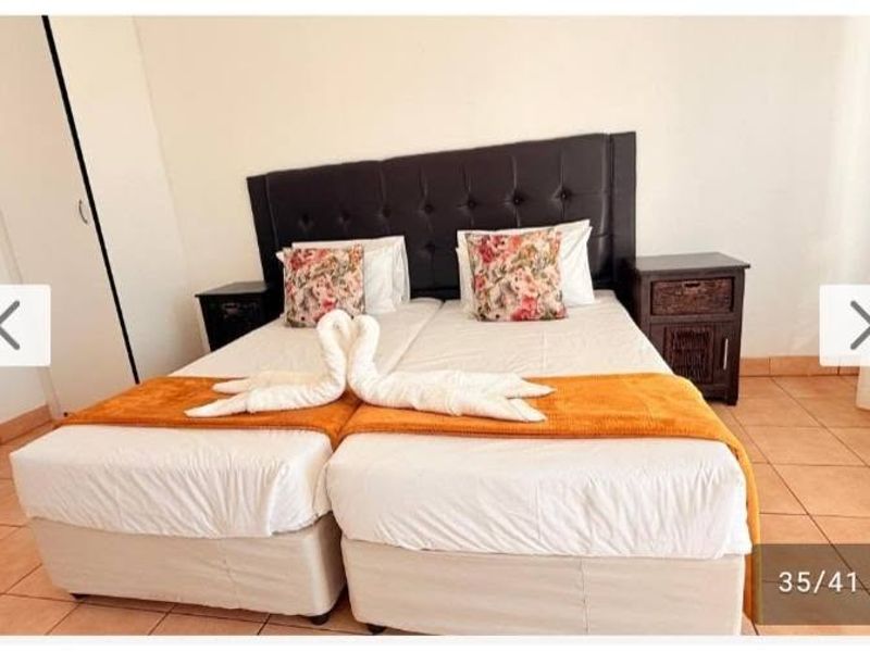 A bedroom featuring tiled flooring and a built-in wardrobe, providing a functional space for rest.