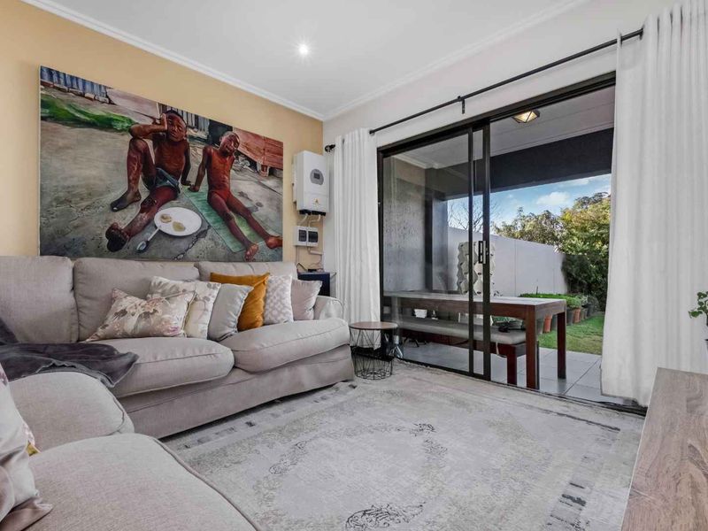 A comfortable living room featuring large sliding glass doors that provide seamless access to the outdoor patio area.
