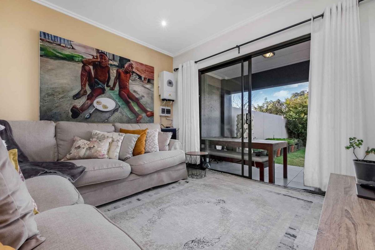 A comfortable living room featuring large sliding glass doors that provide seamless access to the outdoor patio area.