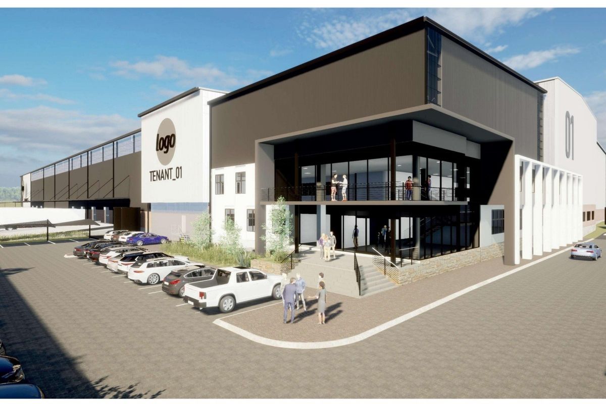A modern industrial facility featuring a multi-level office entrance, expansive warehouse space, and dedicated parking area.