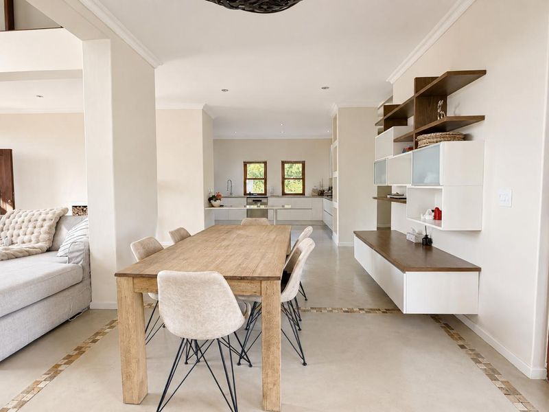 Spacious open-plan living and dining area featuring modern built-in cabinetry, sleek finishes, and a seamless flow into the kitchen space.