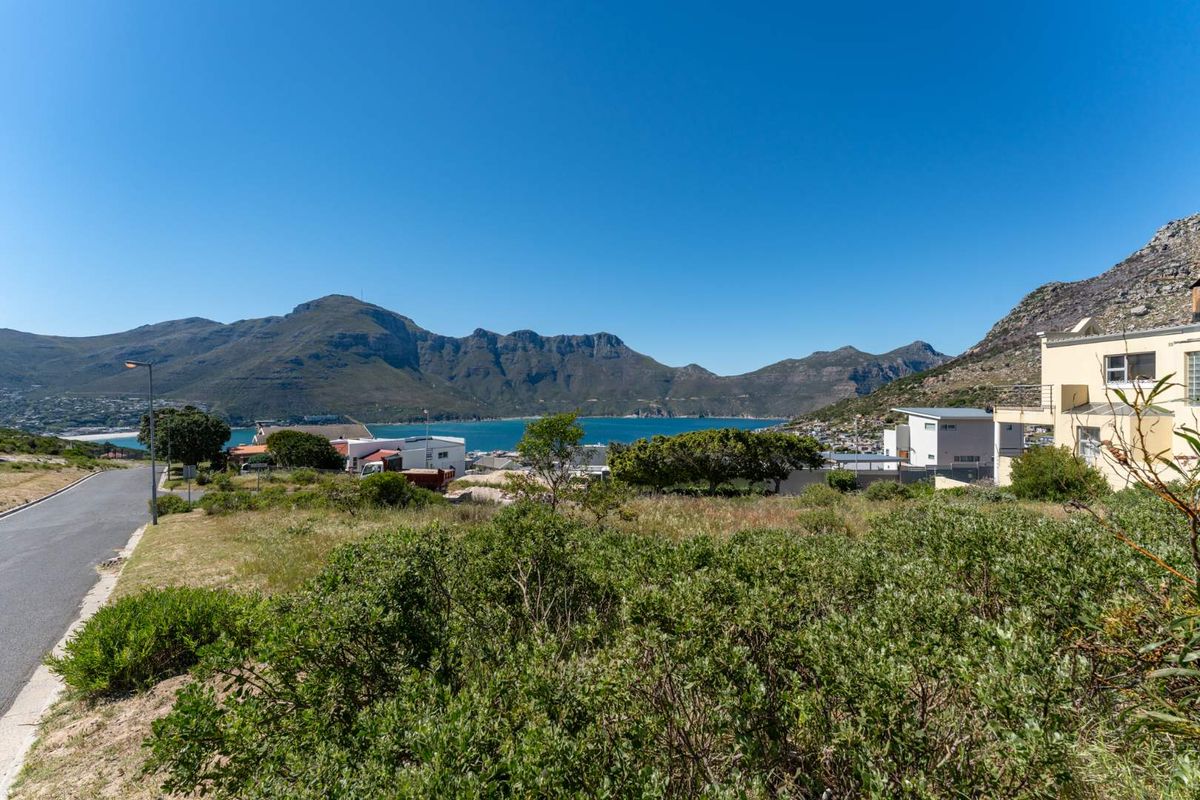 A scenic view overlooking the coastal landscape, bay, and surrounding mountains from the residential vacant land.
