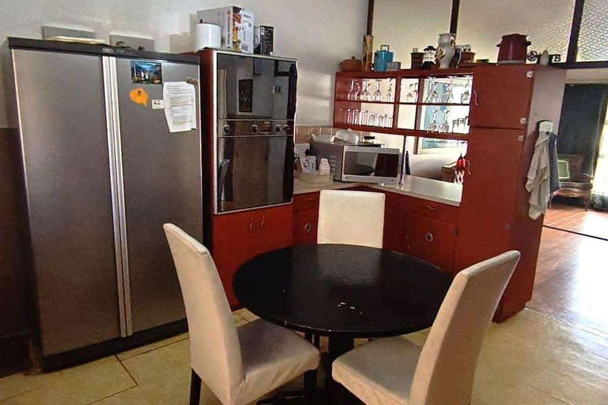 A dated kitchen area featuring built-in cabinetry and an integrated oven, offering potential for modernization and layout optimization.