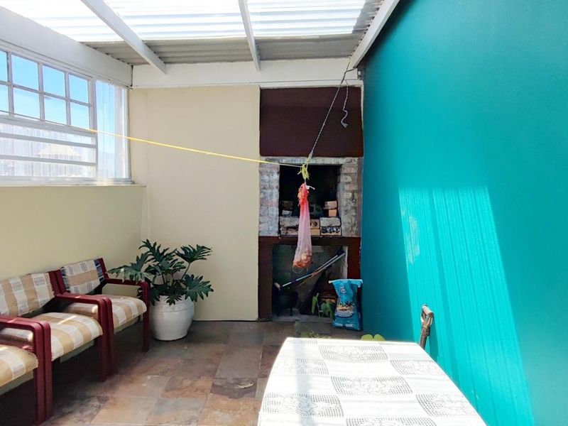 Versatile Coastal Living: Three-Bedroom Home with Income-Generating Flats - Photo 6