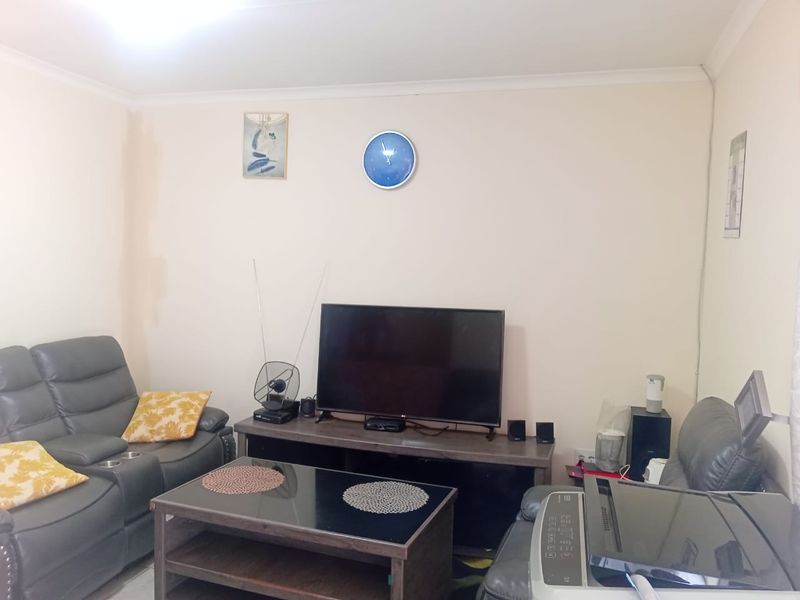 A standard living room space with neutral wall finishes, suitable for modernization and updated interior design.
